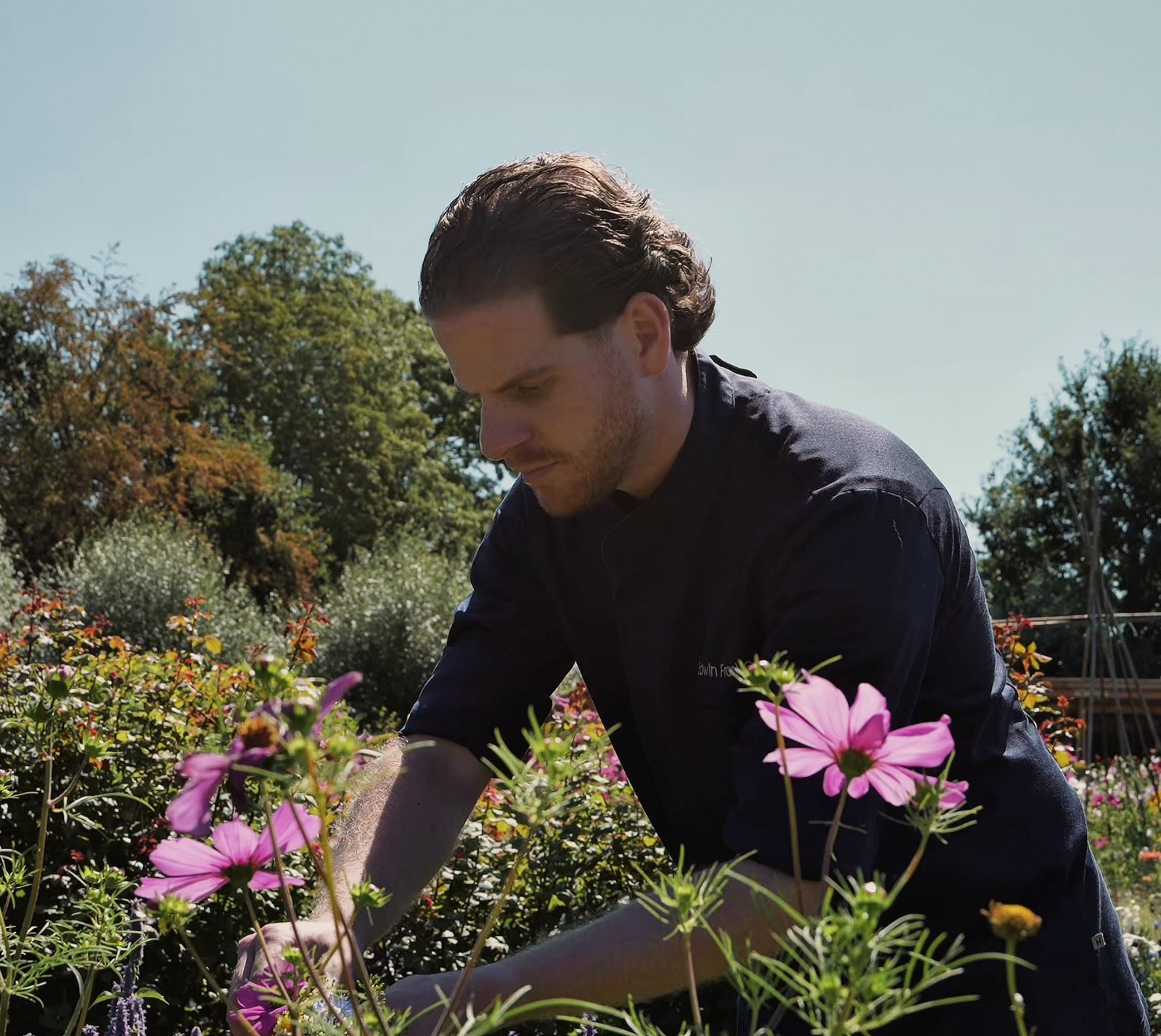 Edwin cutting flowers in the cutting garden